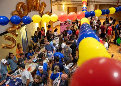 Crowd of KU students at Union Fest with balloons of various colors over head